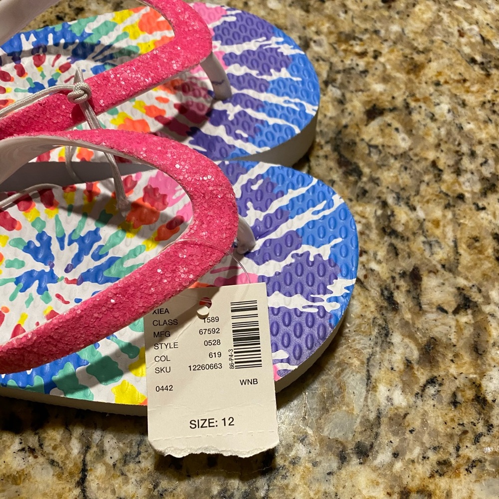 Two pairs of Justice Flip Flops.
